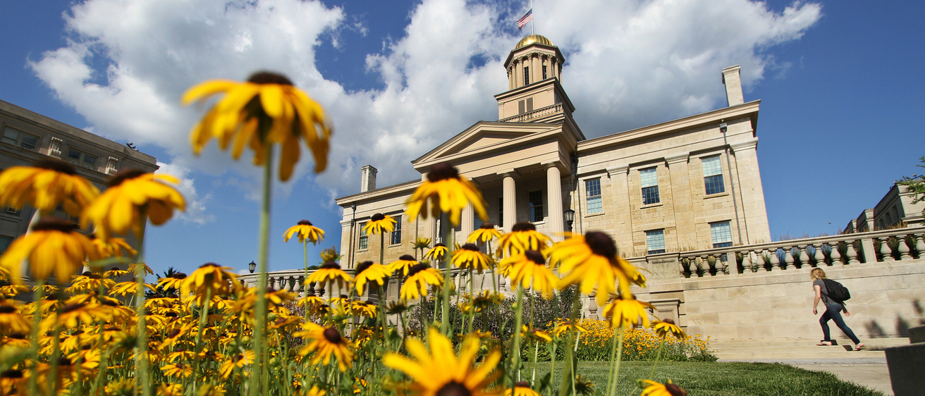 Yellow flowers in front of the Old Capitol building on the campus of the University of Iowa.